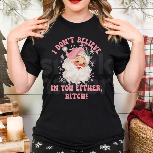 Santa's, I don't believe in you either bitch, pink letters on black tee. 