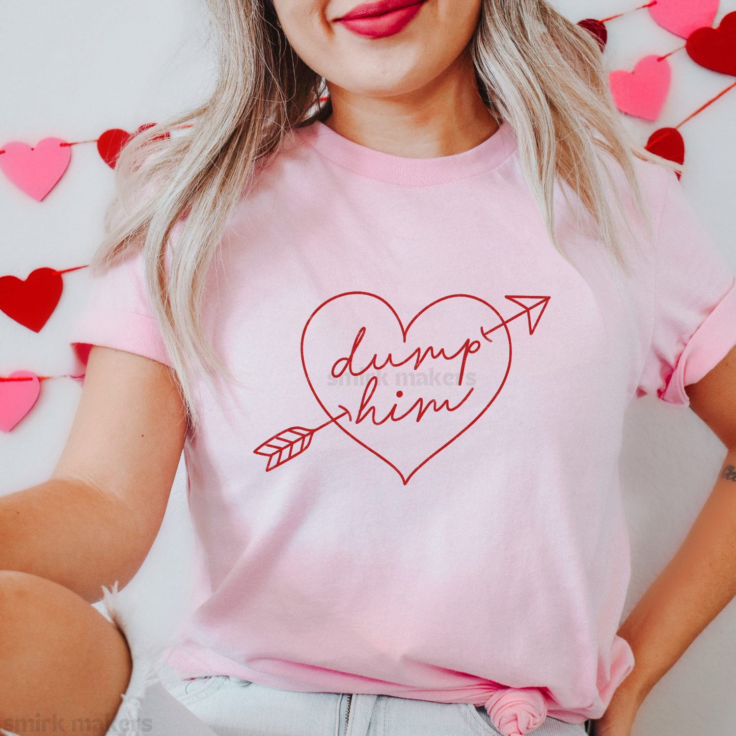 Red "Dump him" heart on pink tee.